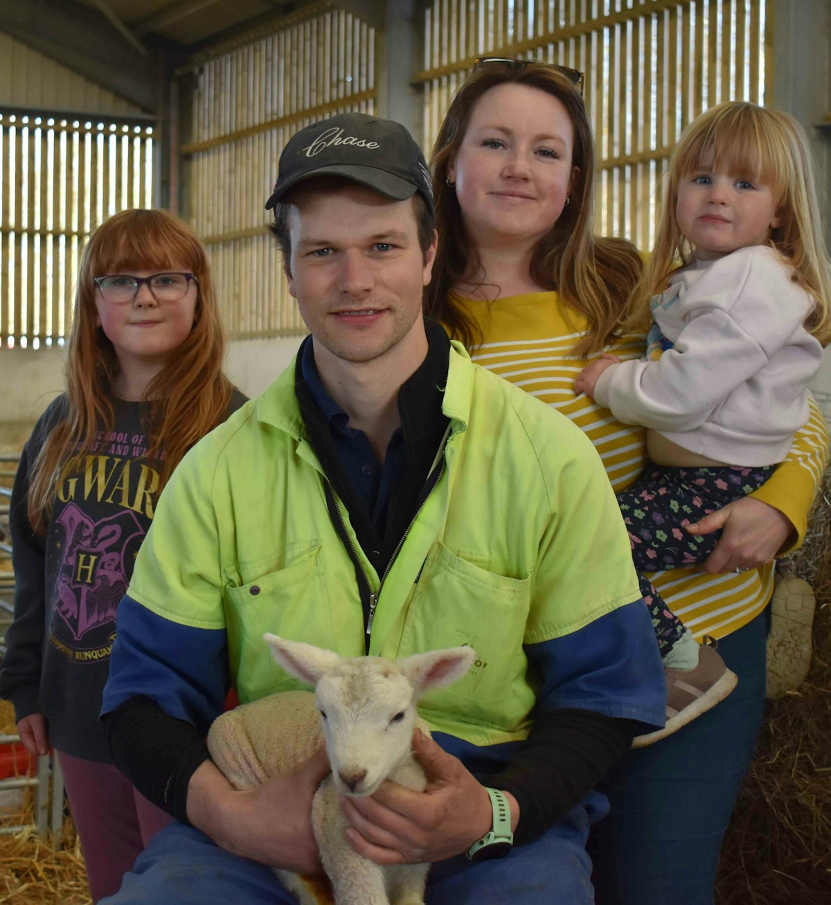 The Mann family and a baby lamb